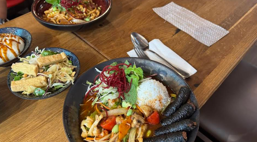 A spread of starters — bao, spring rolls, hot bowl and fresh salad