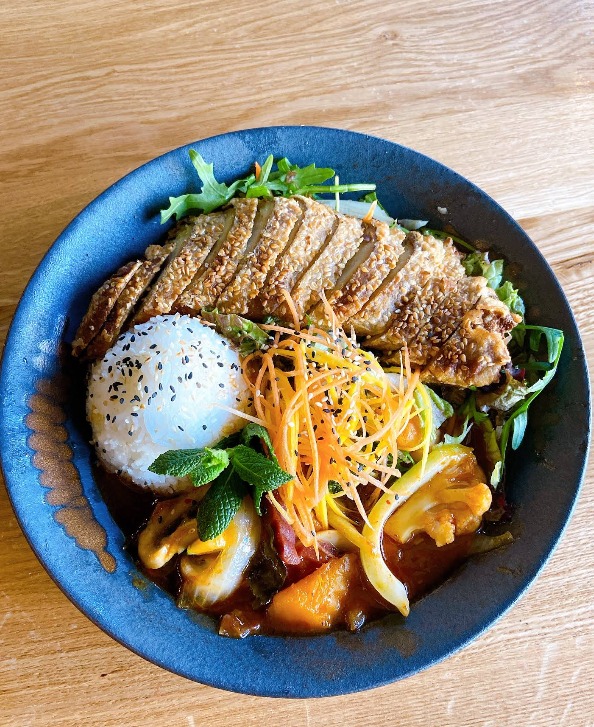 Homemade coconut curry bowl topped with a crispy sesame cutlet and rice