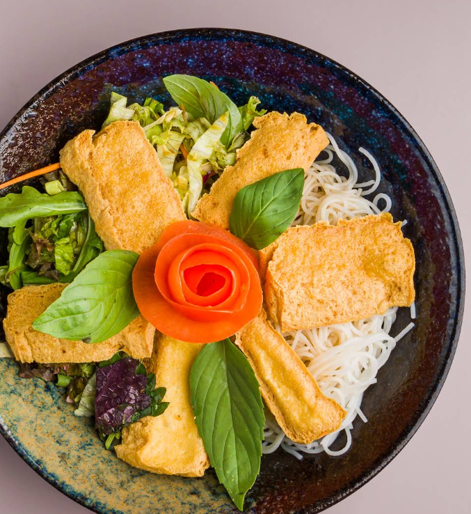 Crispy tofu in rice-flake coating, fanned over rice vermicelli with herbs